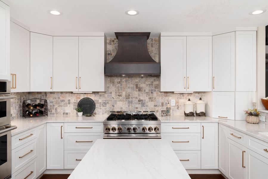 White Kitchen With Stone Backsplash Stainless Steel Appliances